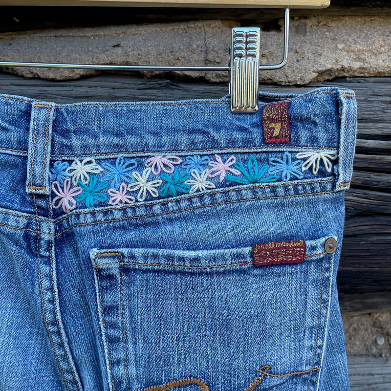 Close up of the embroidered flowers on the back right waistband.