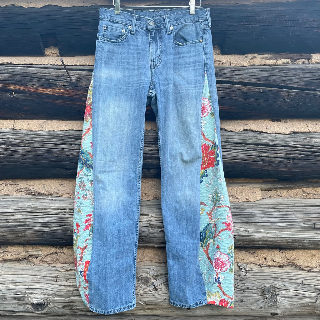 Front of Tessa Hand me Down Jeans with light blue denim wash and flower fabric inserts.