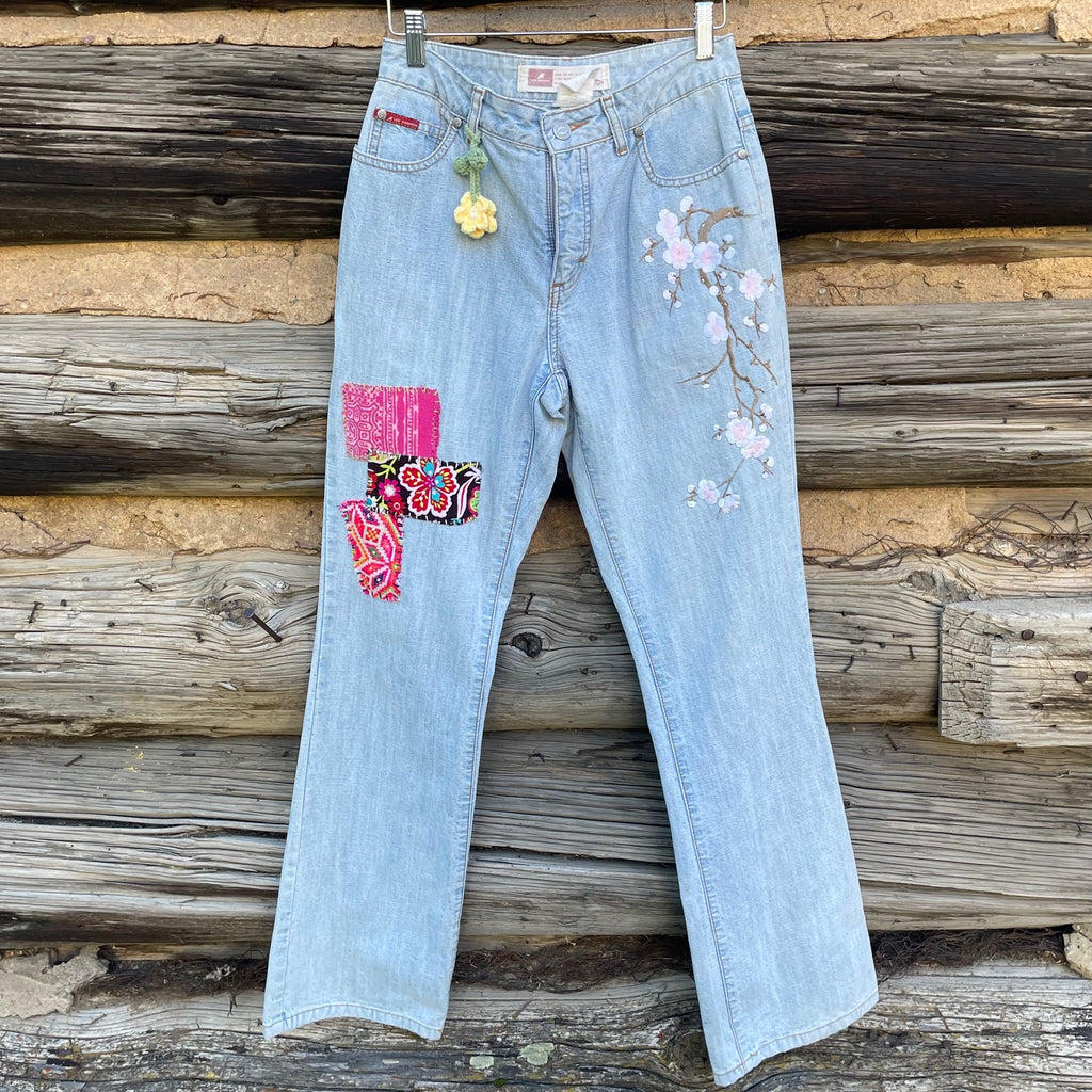 Front of Patch Jeans with fabric patches and flower embellishments.