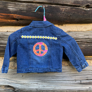 Back of jean jacket with peace sign patch.