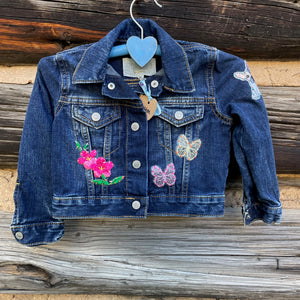 Front of Jean Jacket with flower and butterfly patches.