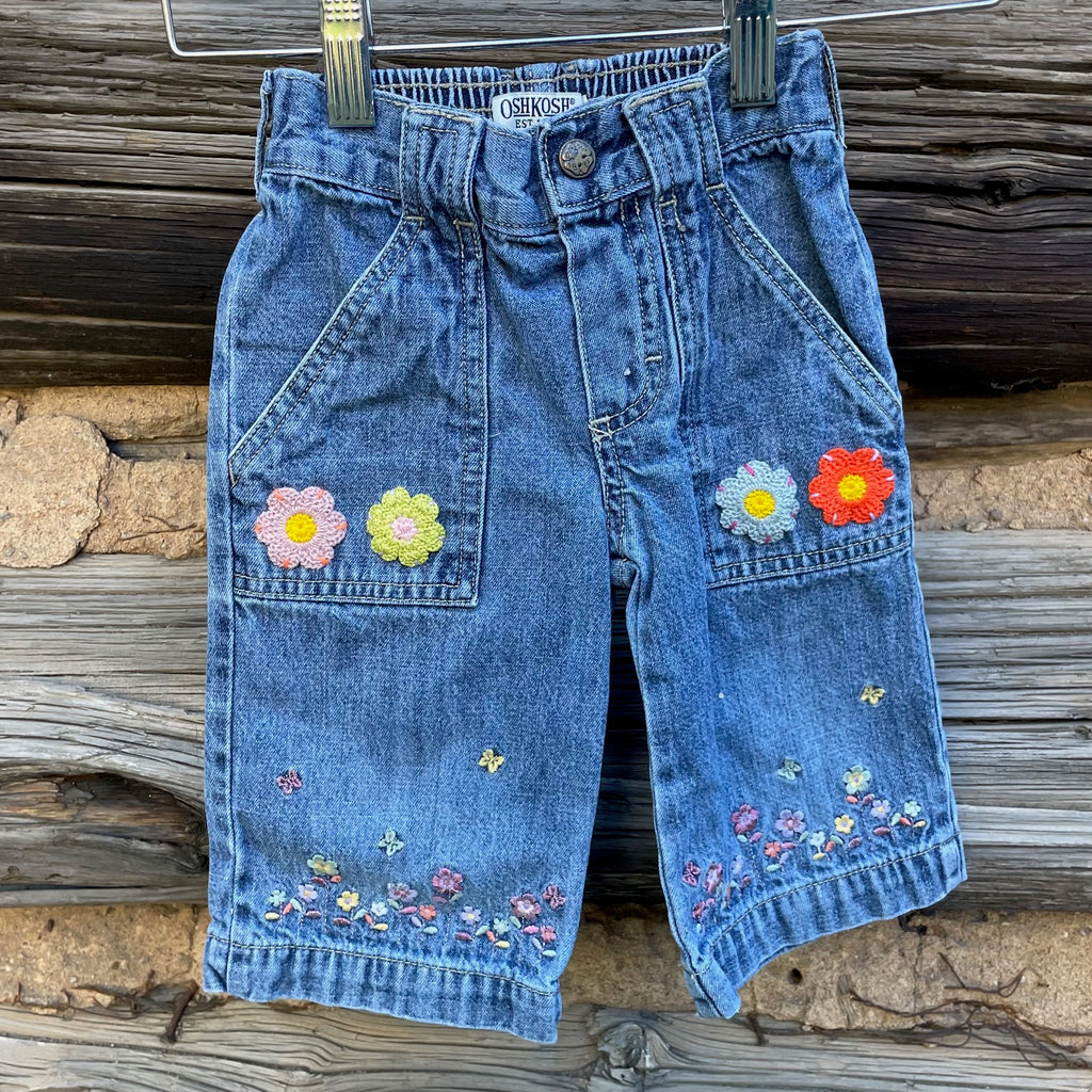 Front of kids jeans with flower embroidery