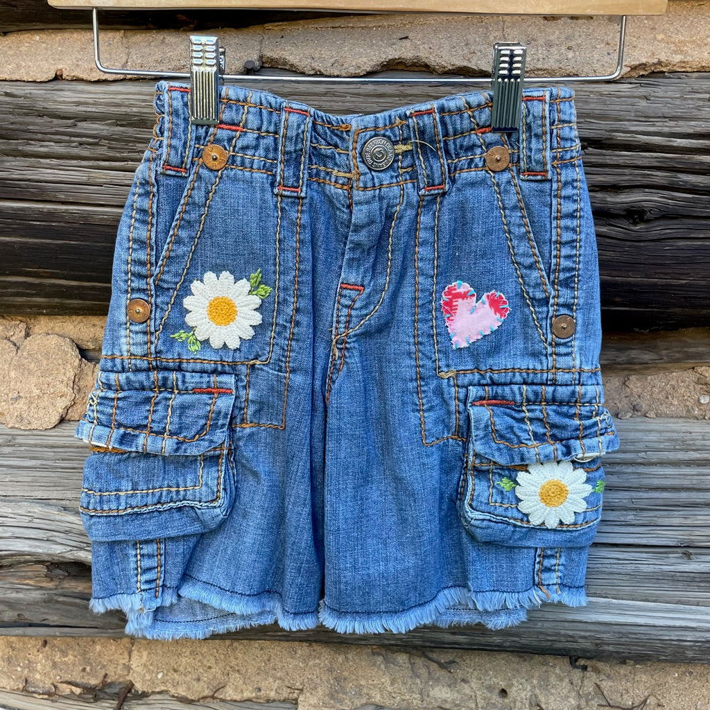 Front of Jean shorts with flower patches