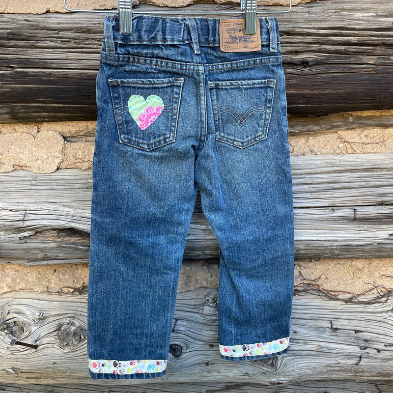 Back of jeans with heart fabric patch.