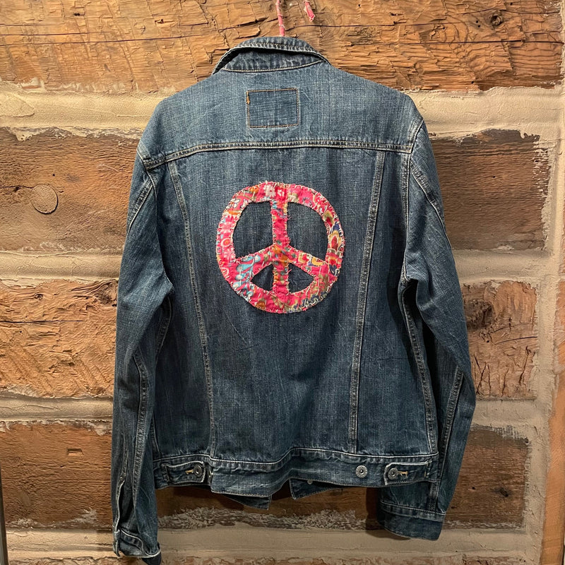 Denim jacket with a peace symbol patch 