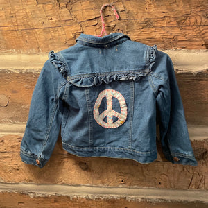 Blue denim jacket with peace symbol patch