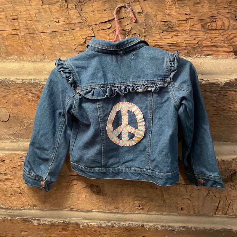Blue denim jacket with peace symbol patch