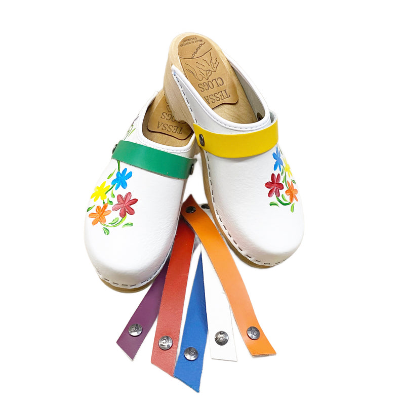 Traditional heel with handpainted Axelina design in pride colors of red, orange, yellow, blue, and purple flowers. The grass green snap strap is shown on the left and the yellow on the right.