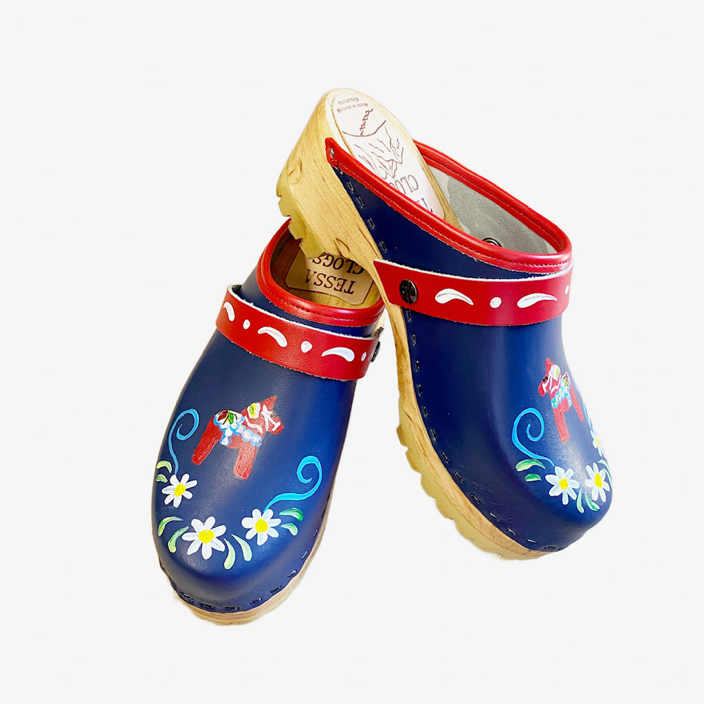 Mountain Sole Clog with blue leather and handpainted Dalahorse design featuring a red edgeband and red with white scroll snap straps