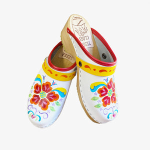 White leather on our traditional heel with natural stain,  our hand painted Petra design, a red edgeband, and yellow with orange scroll straps.