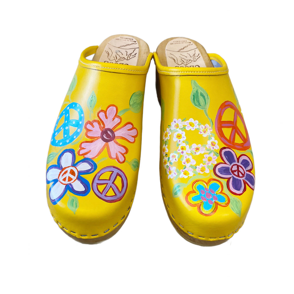 Yellow Christy Peace Design clogs on the traditional heel