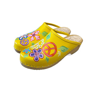 Yellow Christy Peace Design clogs on the traditional heel from the left view