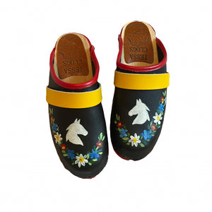 Pair of black clogs with horse and floral design on a white background