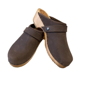 A pair of dark brown leather clogs with natural wood  heels , displayed against a solid white background.