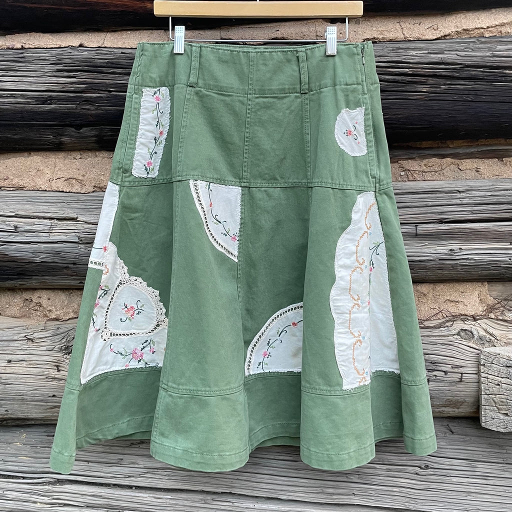 Green denim skirt with vintage napkin patches.