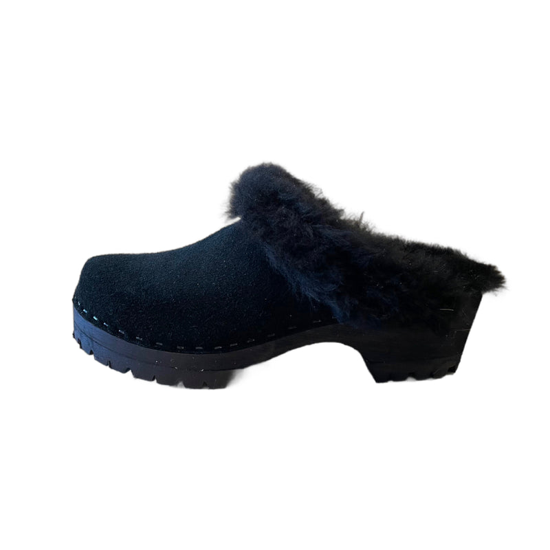 Mountain sole Tessa clog with a stained black wooden sole. Made with black suede and lined with black shearling.