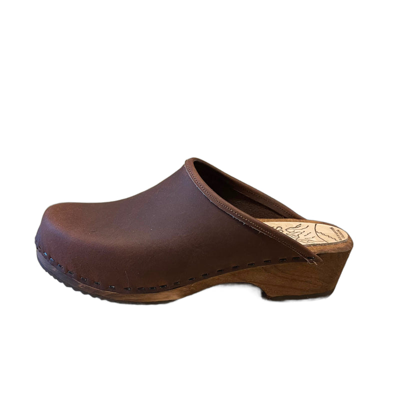 Traditional heel Tessa clog in our featured cocoa bean leather on a brown stain wood sole with a brown edge band and no strap.