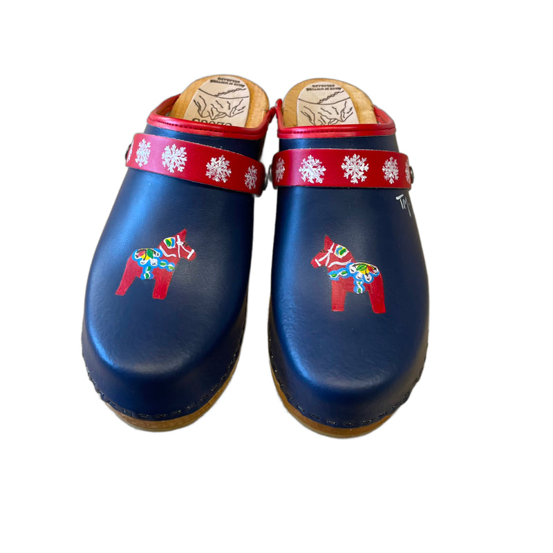 Traditional heel Tessa clog in navy blue leather with hand-painted Dala horse design on front of shoe and a snowflake painted snap strap.