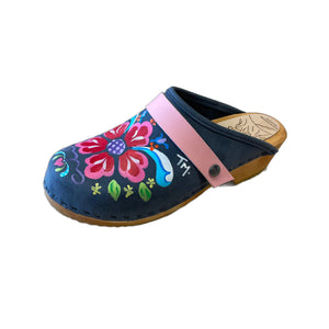 Traditional heel Tessa clog in denim blue leather and natural wood stained soles with the hand painted Petra design and a plain baby pink snap strap.