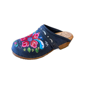 Traditional heel Tessa clog in denim blue leather and natural wood stained soles with the hand painted Petra design and a painted dashed denim blue snap strap.