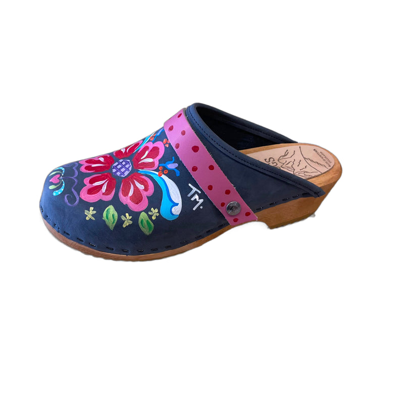 Traditional heel Tessa clog in denim blue leather and natural wood stained soles with the hand painted Petra design and a painted hot pink with red polka dot snap strap.