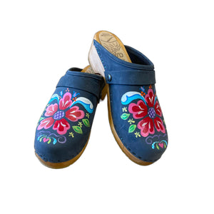 Traditional heel Tessa clog in denim blue leather and natural wood stained soles with the hand painted Petra design and a plain denim blue snap strap.