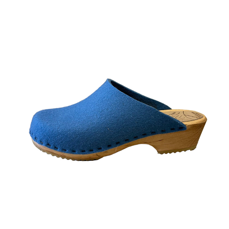 Blue clog shoe with wooden sole on a white background