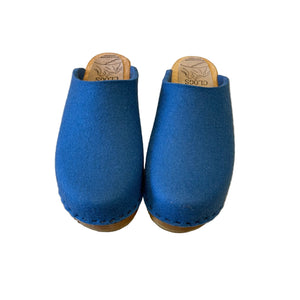 blue felt wool clogs on wooden sole and white background