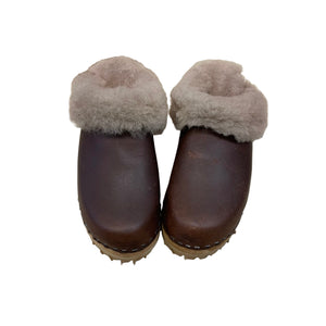 Pair of brown wooden clogs with pink brown fur lining.