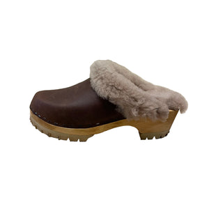 Brown clog shoe with fur lining on a white background