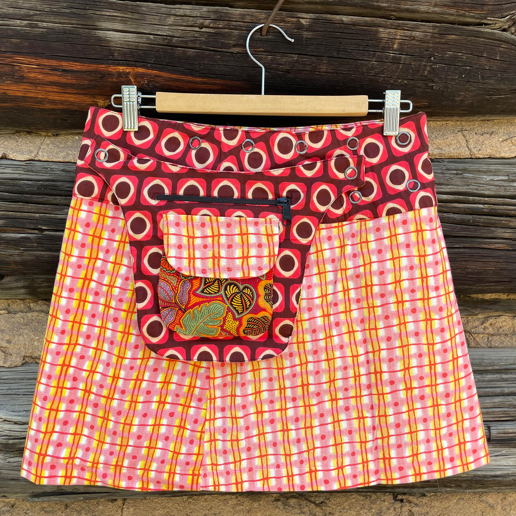 Asha Reversible Wrap Skirt side A with light pink, yellow, orange, and red printed fabric