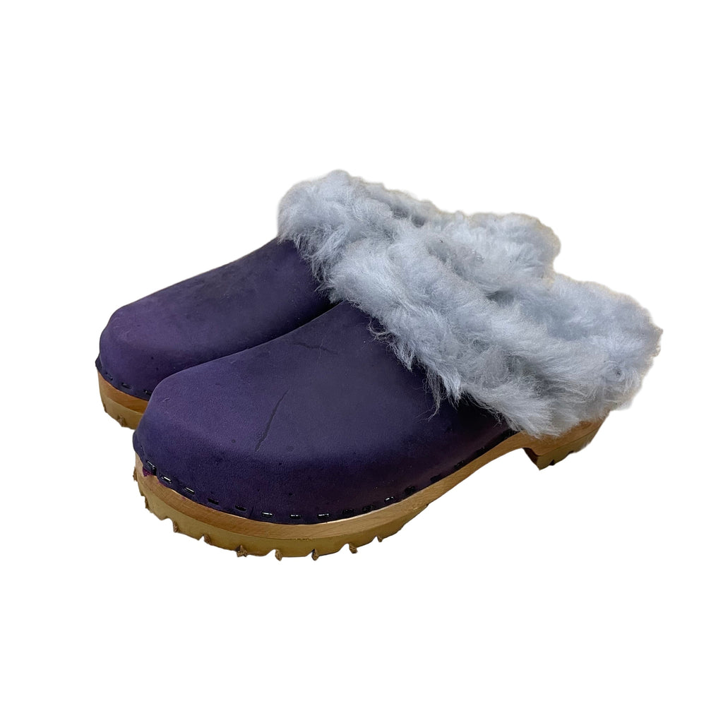 purple clogs with blue fur trim on a white background