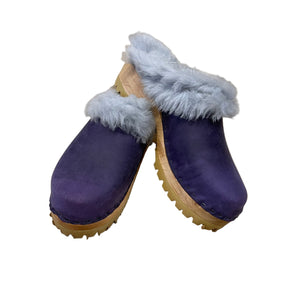 Pair of shearling lined purple leather clogs on white background