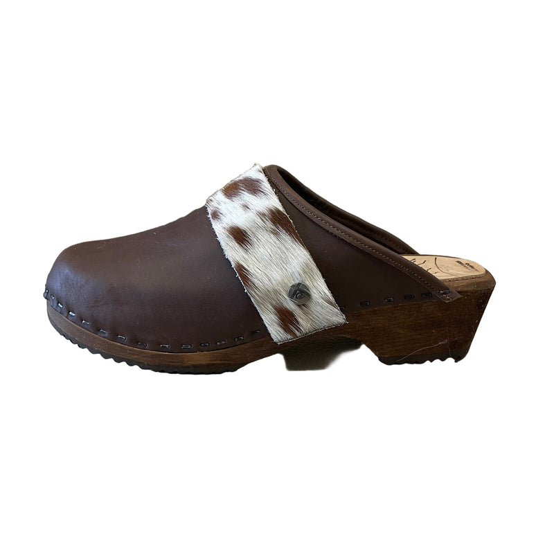 Brown clog shoe with cowhide strap on a white background