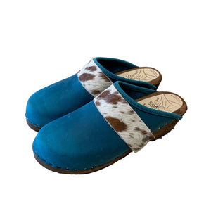 Pacific blue clog with cowhide straps on a white background
