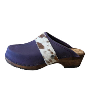 Purple clogs with cowhide straps on a white background