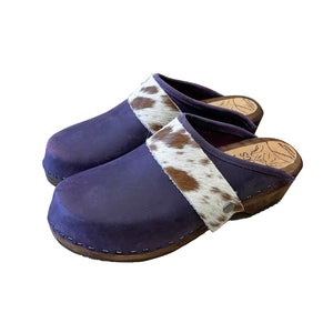 purple clogs with cowhide straps on a white background