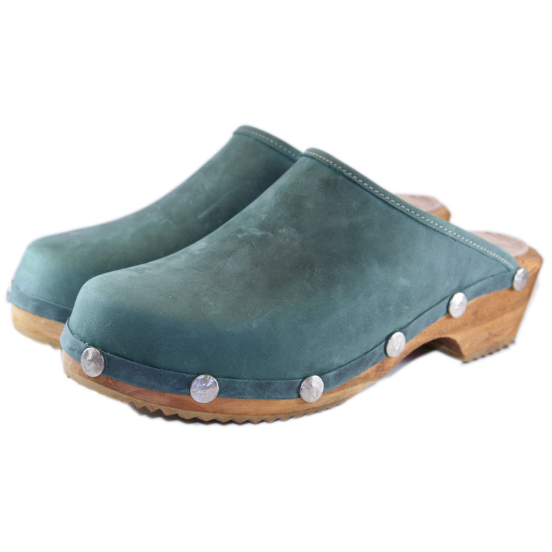 Leather clogs in Pine Green on a wooden heel